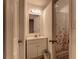 Bathroom with a single sink vanity, mirror, toilet, and shower at 3707 Cambridge St, New Port Richey, FL 34652