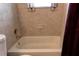 Close-up of a clean white bathtub with tiled walls and a shower head at 3707 Cambridge St, New Port Richey, FL 34652