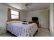 Bedroom with tile floors, a patterned quilt, and cats at 3707 Cambridge St, New Port Richey, FL 34652