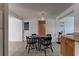 A dining area with tile floors, a table with four chairs, and access to other rooms at 3707 Cambridge St, New Port Richey, FL 34652