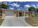 Inviting single-story home with attached garage, front lawn, and charming covered entryway at 3707 Cambridge St, New Port Richey, FL 34652