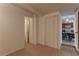 Hallway with tile floor, closet, and access to kitchen and rooms at 3707 Cambridge St, New Port Richey, FL 34652