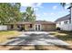 Backyard features a large gray patio, a flat grassy yard, and lush trees at 3907 W Azeele St, Tampa, FL 33609