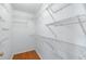 Walk-in closet featuring shelving and hardwood flooring at 3907 W Azeele St, Tampa, FL 33609