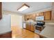 Well-lit kitchen featuring light wood cabinets, stainless steel appliances, and adjoining living area at 3907 W Azeele St, Tampa, FL 33609