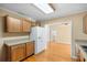 Functional kitchen featuring a white refrigerator, wooden cabinets, hardwood floors, and open access at 3907 W Azeele St, Tampa, FL 33609