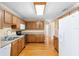 Functional kitchen with wooden cabinets, stainless steel appliances, and hardwood floors at 3907 W Azeele St, Tampa, FL 33609