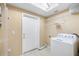 A bright laundry room with a skylight, laundry machine, and wire shelving at 3907 W Azeele St, Tampa, FL 33609