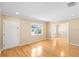 Bright living room featuring gleaming hardwood floors, a large window, and neutral wall colors at 3907 W Azeele St, Tampa, FL 33609