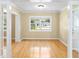 Bright living room featuring gleaming hardwood floors, a large window, neutral wall colors, and crown molding at 3907 W Azeele St, Tampa, FL 33609