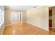 Bright living room featuring gleaming hardwood floors, neutral wall colors, and entry to other rooms at 3907 W Azeele St, Tampa, FL 33609