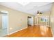 Open-concept living area with skylight, fan, hardwood floors, connecting the kitchen and sunroom at 3907 W Azeele St, Tampa, FL 33609