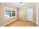 Bright living room featuring gleaming hardwood floors, a large window, neutral wall colors, and crown molding at 3907 W Azeele St, Tampa, FL 33609