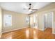 Spacious main bedroom with hardwood floors, natural light, ceiling fan, and en-suite bathroom at 3907 W Azeele St, Tampa, FL 33609