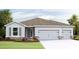 Charming single-story home with a three-car garage and stone accents at 4024 Harvest Hearth Pl, Plant City, FL 33565