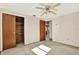Bedroom featuring a ceiling fan, closet and view to adjacent room at 4025 Chesswood Dr, Holiday, FL 34691