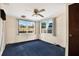 Cozy bedroom with dual windows offering natural light and a ceiling fan at 4025 Chesswood Dr, Holiday, FL 34691