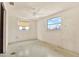 Clean bedroom with bright, natural light from a large window and a ceiling fan at 4025 Chesswood Dr, Holiday, FL 34691