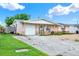 Single story home with a driveway and garage and minimal landscaping at 4025 Chesswood Dr, Holiday, FL 34691