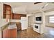 Functional kitchen with wood cabinets, granite countertops, and white appliances at 4025 Chesswood Dr, Holiday, FL 34691