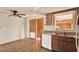 Functional kitchen with wood cabinets, granite countertops, and white appliances at 4025 Chesswood Dr, Holiday, FL 34691