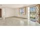 Bright living room features a decorative front door, a large window and concrete floors at 4025 Chesswood Dr, Holiday, FL 34691