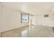 Bright living room features a decorative front door, a large window and concrete floors at 4025 Chesswood Dr, Holiday, FL 34691