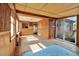Bright sunroom with paneled walls, tiled floor, and sliding glass door at 4025 Chesswood Dr, Holiday, FL 34691