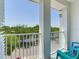 A cozy balcony with seating, offering a tranquil view of the surrounding greenery and neighborhood street at 4503 Legacy Park Dr, Tampa, FL 33611