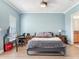 Tranquil bedroom with blue walls, ceiling fan, and modern desk setup, offering a serene and functional space at 4503 Legacy Park Dr, Tampa, FL 33611
