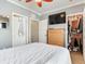 Bright bedroom with a large bed, TV, dresser, and walk-in closet for ample storage space at 4503 Legacy Park Dr, Tampa, FL 33611