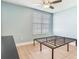 Light blue bedroom with unmade metal bed frame, light floor, and blinds at 4503 Legacy Park Dr, Tampa, FL 33611