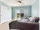 Bright bedroom features balcony access, a ceiling fan, and a functional desk setup, maximizing space and comfort at 4503 Legacy Park Dr, Tampa, FL 33611