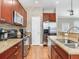 Kitchen view of appliances, tile backsplash, stainless steel refrigerator, and granite countertops at 4503 Legacy Park Dr, Tampa, FL 33611