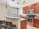 A kitchen showcasing wood cabinets, granite countertops and a breakfast bar at 4503 Legacy Park Dr, Tampa, FL 33611