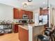 Kitchen island with stainless steel appliances, granite countertops, wood cabinets, and breakfast bar at 4503 Legacy Park Dr, Tampa, FL 33611