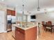 Bright, open-concept kitchen with breakfast bar, dining table, stainless steel fridge and hardwood floors at 4503 Legacy Park Dr, Tampa, FL 33611