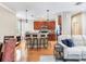 A kitchen with a breakfast bar, wooden cabinets and stainless steel appliances that opens to the living area at 4503 Legacy Park Dr, Tampa, FL 33611