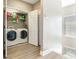 Functional laundry room with modern washer and dryer, plus shelving for supplies, maximizing convenience and organization at 4503 Legacy Park Dr, Tampa, FL 33611
