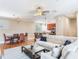 Open-concept living room, dining room, and kitchen with hardwood floors and modern lighting at 4503 Legacy Park Dr, Tampa, FL 33611