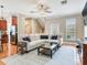 Spacious living room featuring an L-shaped sofa, wood floors, and a ceiling fan at 4503 Legacy Park Dr, Tampa, FL 33611