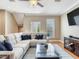 Bright living room featuring a large sectional sofa, modern furnishings, and a view of the outdoor scenery at 4503 Legacy Park Dr, Tampa, FL 33611