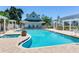 Community pool with blue water, surrounding buildings, and brick deck is perfect for relaxing at 4503 Legacy Park Dr, Tampa, FL 33611