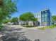 Street view of multiple light blue condo buildings with garages and balconies on a sunny day at 4503 Legacy Park Dr, Tampa, FL 33611