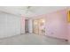 Large pink bedroom with an adjacent sun room featuring a closet and good natural light, awaiting renovations at 4720 Coronado S Way, Gulfport, FL 33711