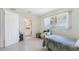 Bright bedroom with an ensuite, featuring a window view and neutral decor, awaiting personal touches at 4720 Coronado S Way, Gulfport, FL 33711
