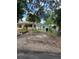 Fenced backyard featuring a gate with chain link fence, with the main house at the front of the yard at 4720 Coronado S Way, Gulfport, FL 33711
