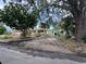 Charming single-story home with spacious driveway and mature trees in a serene neighborhood at 4720 Coronado S Way, Gulfport, FL 33711