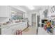 Well-lit kitchen featuring white cabinetry, quartz countertops, modern appliances, and a large window at 4720 Coronado S Way, Gulfport, FL 33711