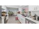 Bright kitchen with white cabinets, stainless steel appliances, quartz countertops, and abundant natural light at 4720 Coronado S Way, Gulfport, FL 33711